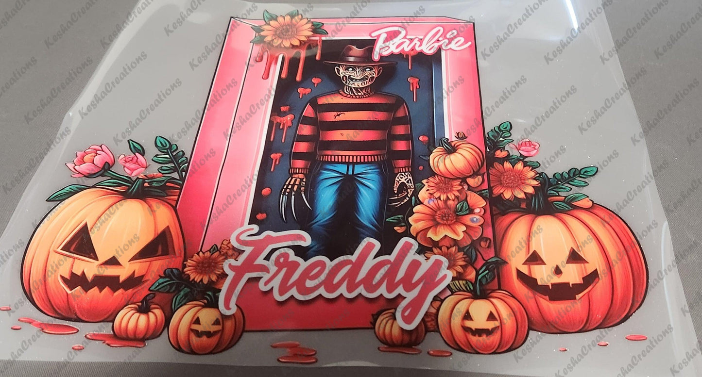 DTF transfer design featuring Freddy Krueger inside a pink Barbie box, surrounded by pumpkins, flowers, and dripping blood effects, with 'Freddy' written below